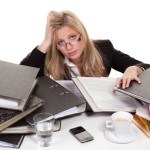 Woman struggling on papers, books and work