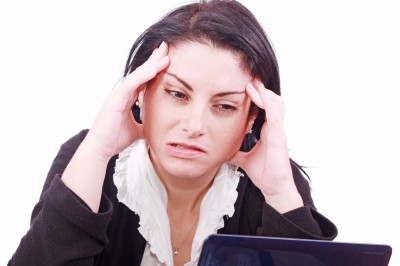 a Woman struggling in front of a laptop