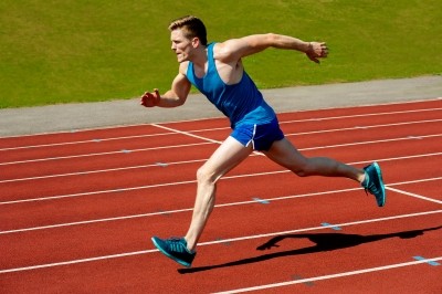 Young Caucasian Athlete Sprinting On Track