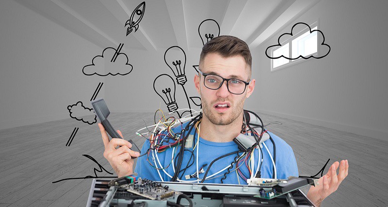 Composite image of confused young it professional with cables an