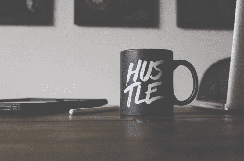 hustle written on a mug