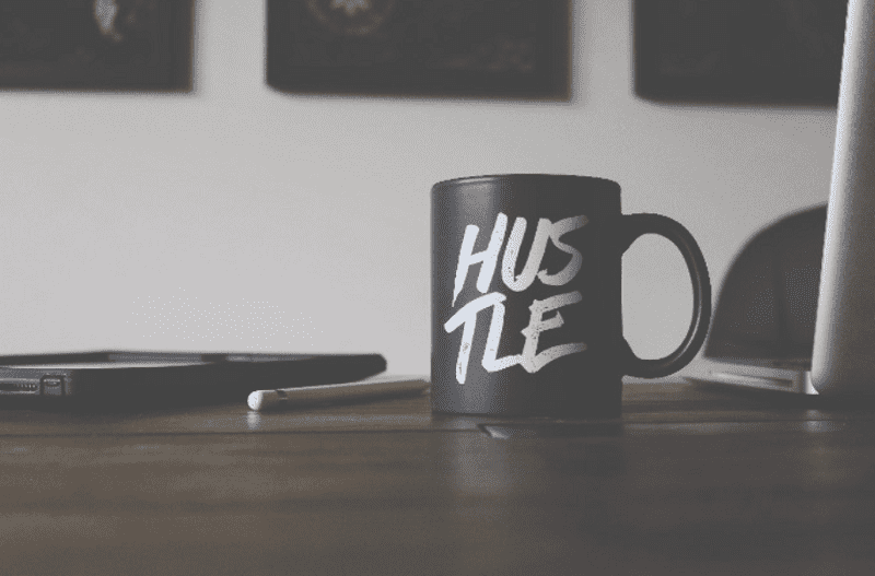 hustle written on a cup