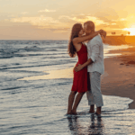 couple-kissing-on-beach-during-golden-hour